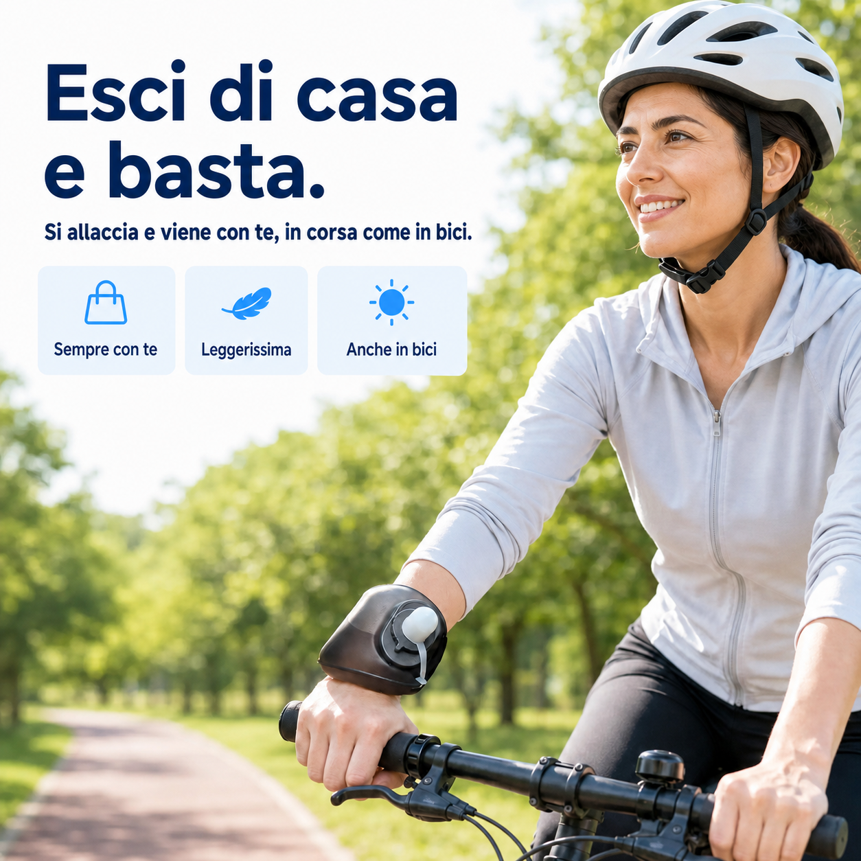 Ciclista in sella su una strada tra gli alberi, con la HydraBand allacciata al polso destro